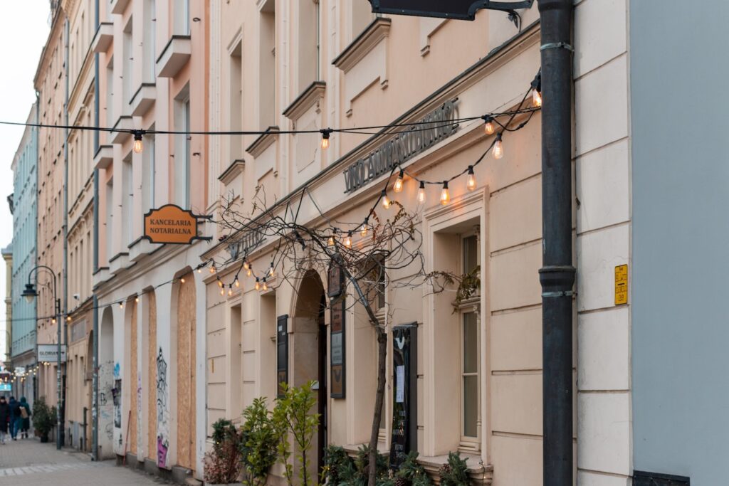 Building facade with string lights and arched entrance.